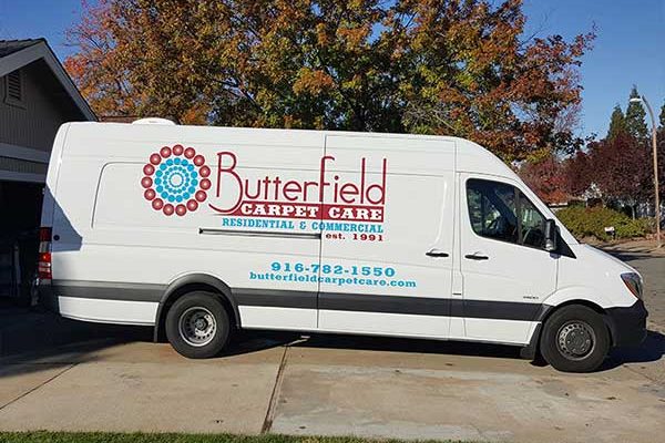 Butterfield Carpet Care Sprinter van with printed logo graphics and phone number